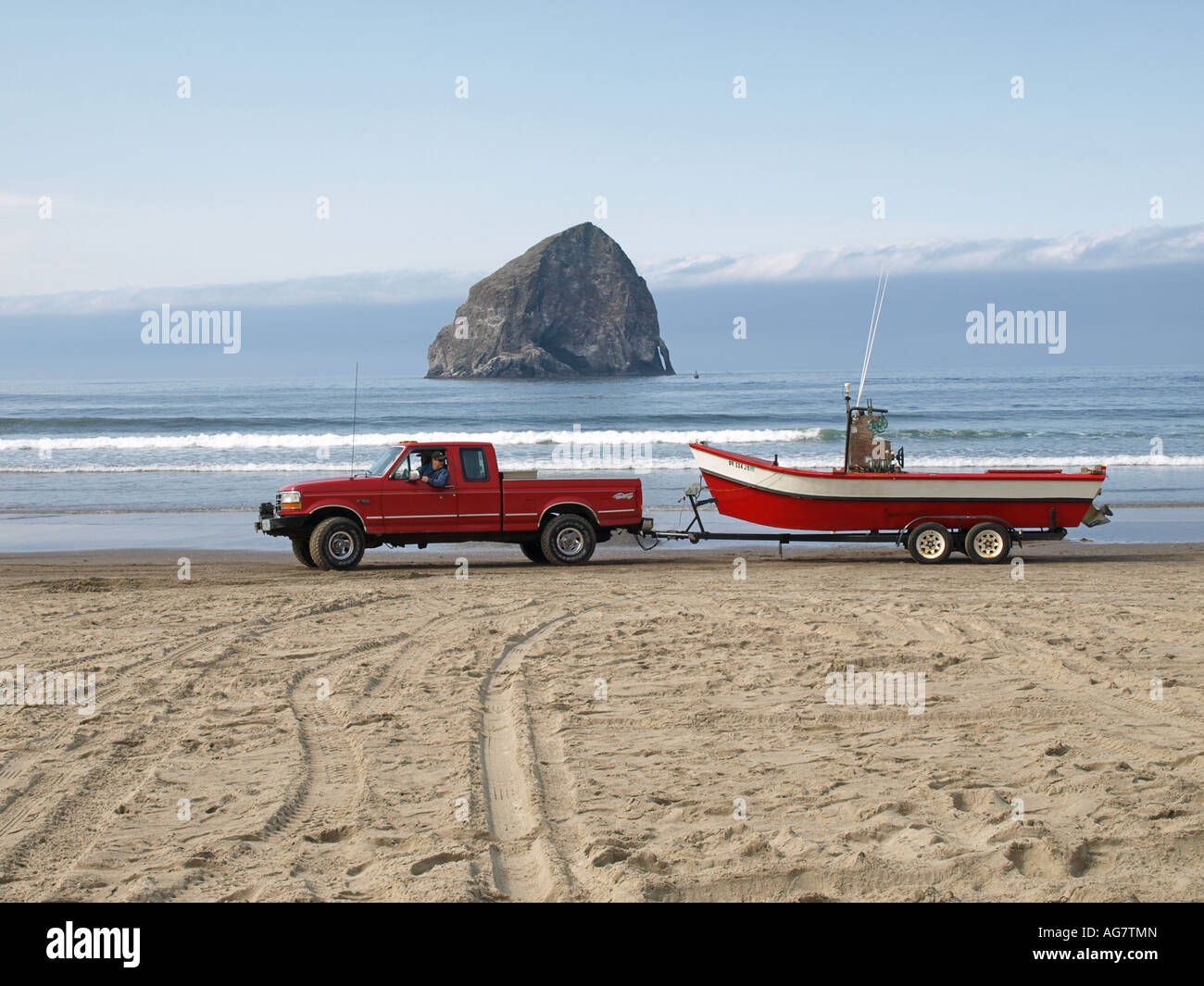 A view of the Pacific City dory fishing fleet launching from the beach in Pacific City Stock Photo
