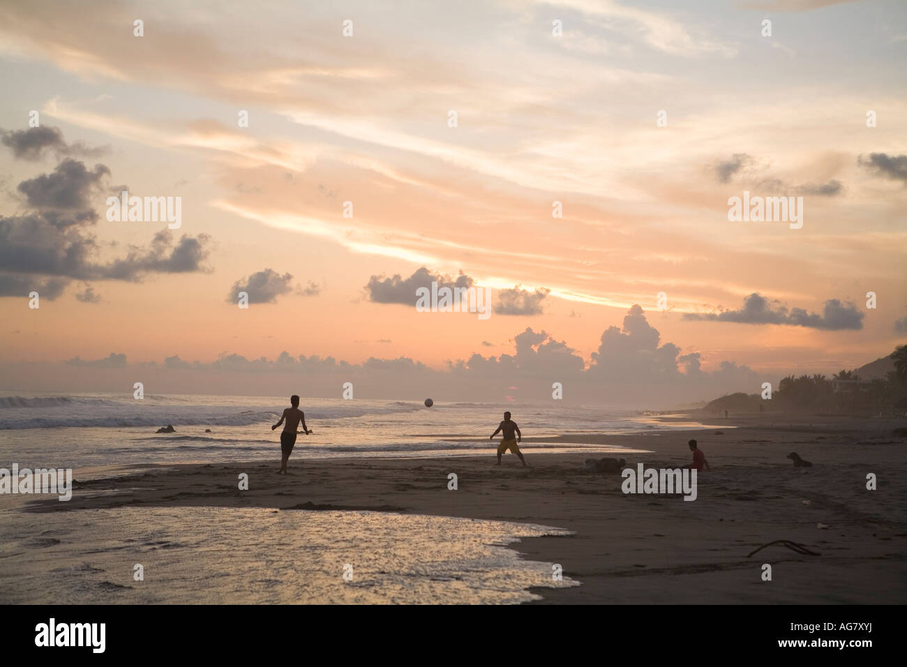Sunset silhouettes two boys playing soccer on Troncones Beach State of Guerrero Mexico. Not Model Released Stock Photo