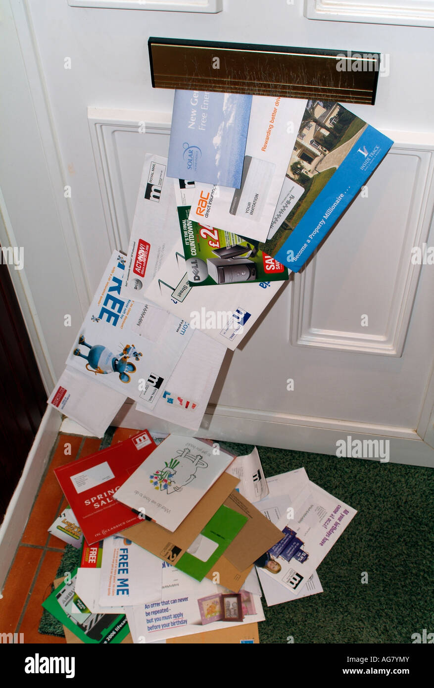 Junk Mail Unwanted Mail Posted Through a Front Door Letterbox Stock Photo
