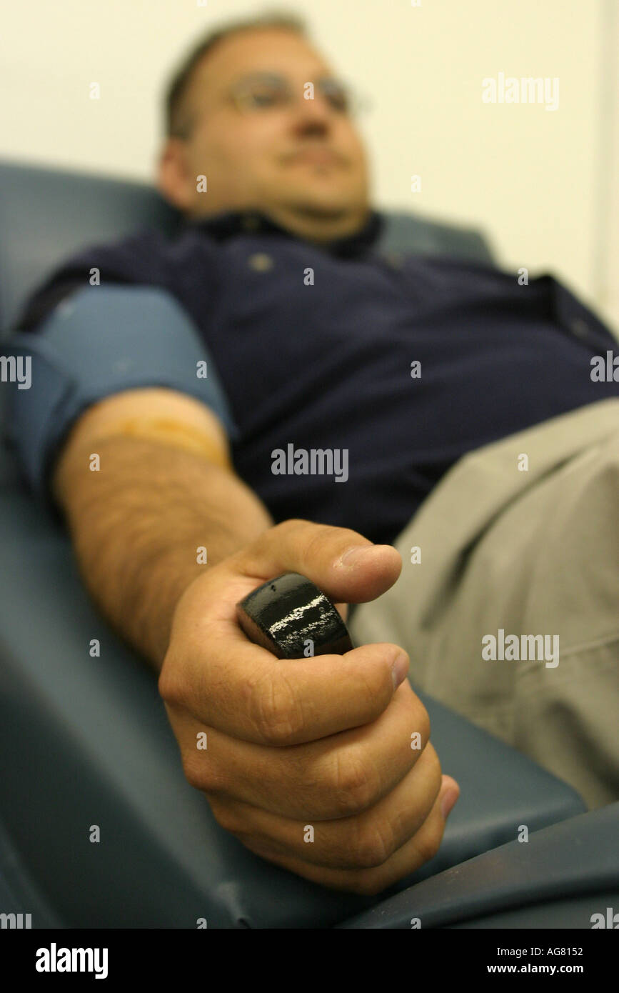 A man donating plasma at a plasma center in Portland Oregon Stock Photo