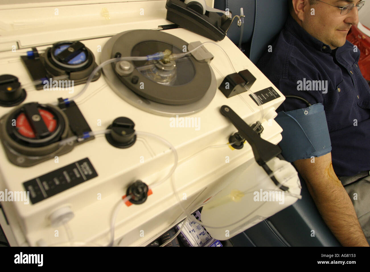 A man donating plasma at a plasma center in Portland Oregon Stock Photo