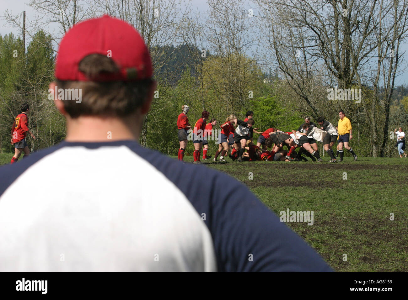 A coach watches a women s rugby game in action during the scrum as players fight for the ball at a game in Oregon Stock Photo
