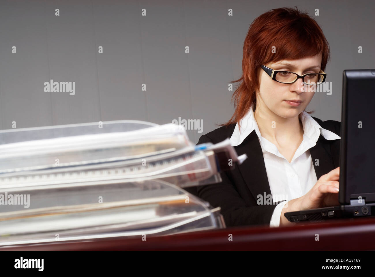 Overworked woman at computer Stock Photo