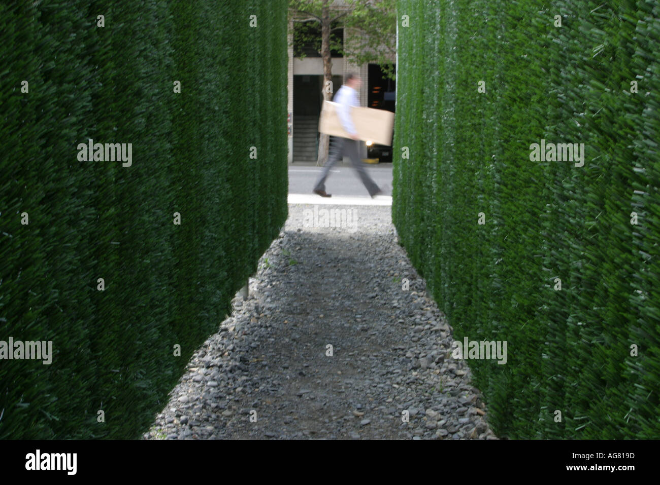 A man walks by a piece of public art in downtown Portland Oregon Stock Photo