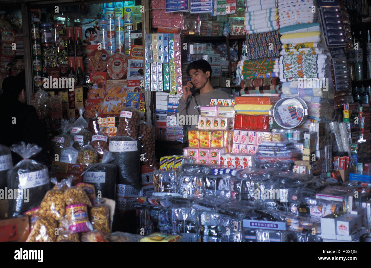 Vietnam Hanoi Shopkeeper conversing on phone Stock Photo