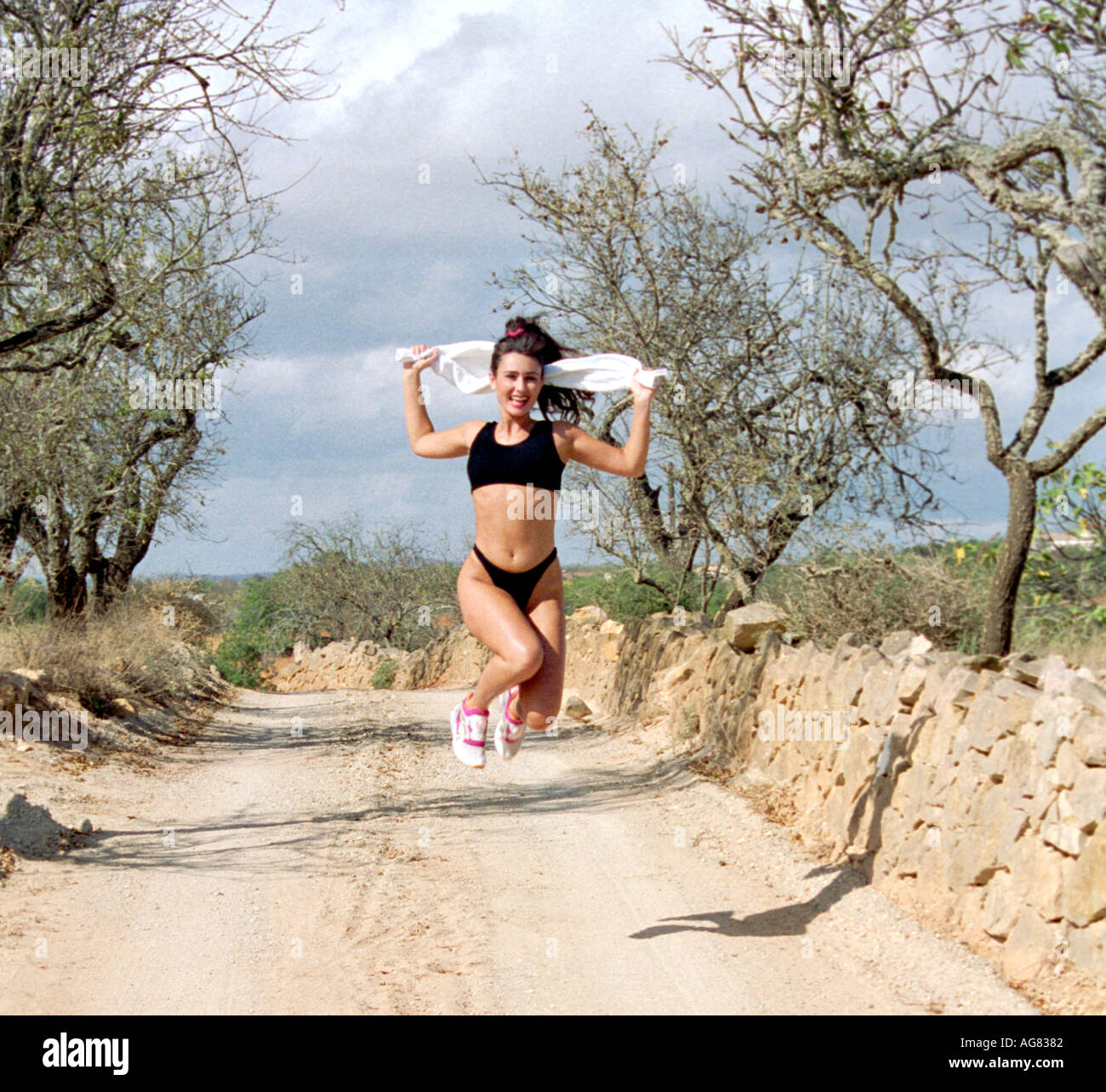 Young Woman Jogging in the Countryside Stock Photo