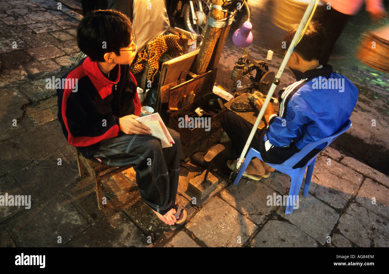 Vietnam Hanoi Cobbler repairing shoe Stock Photo
