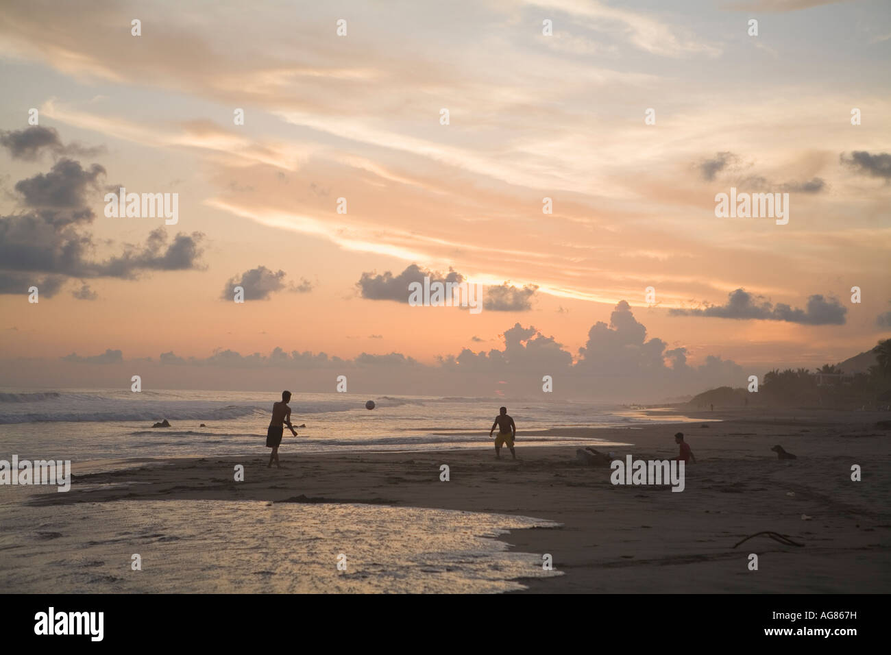 Sunset silhouettes two boys playing soccer on Troncones Beach State of Guerrero Mexico. Not Model Released Stock Photo