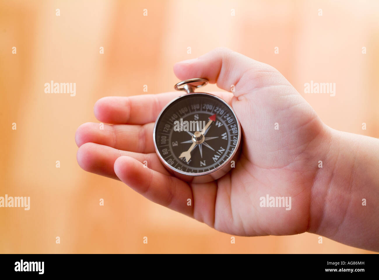 Person holding compass Stock Photo