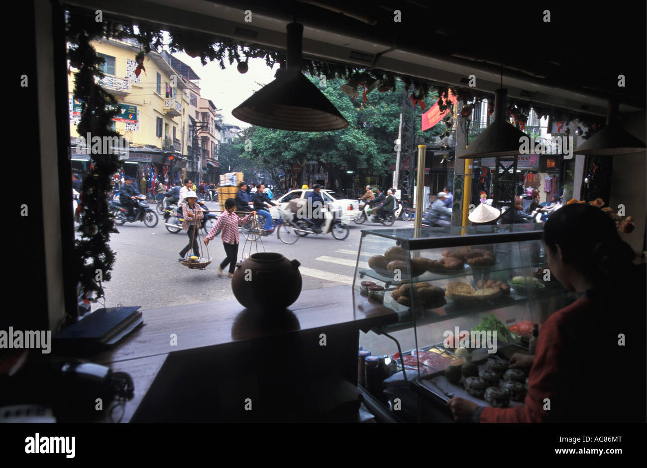 Vietnam Hanoi Woman serving cakes in coffee shop Stock Photo