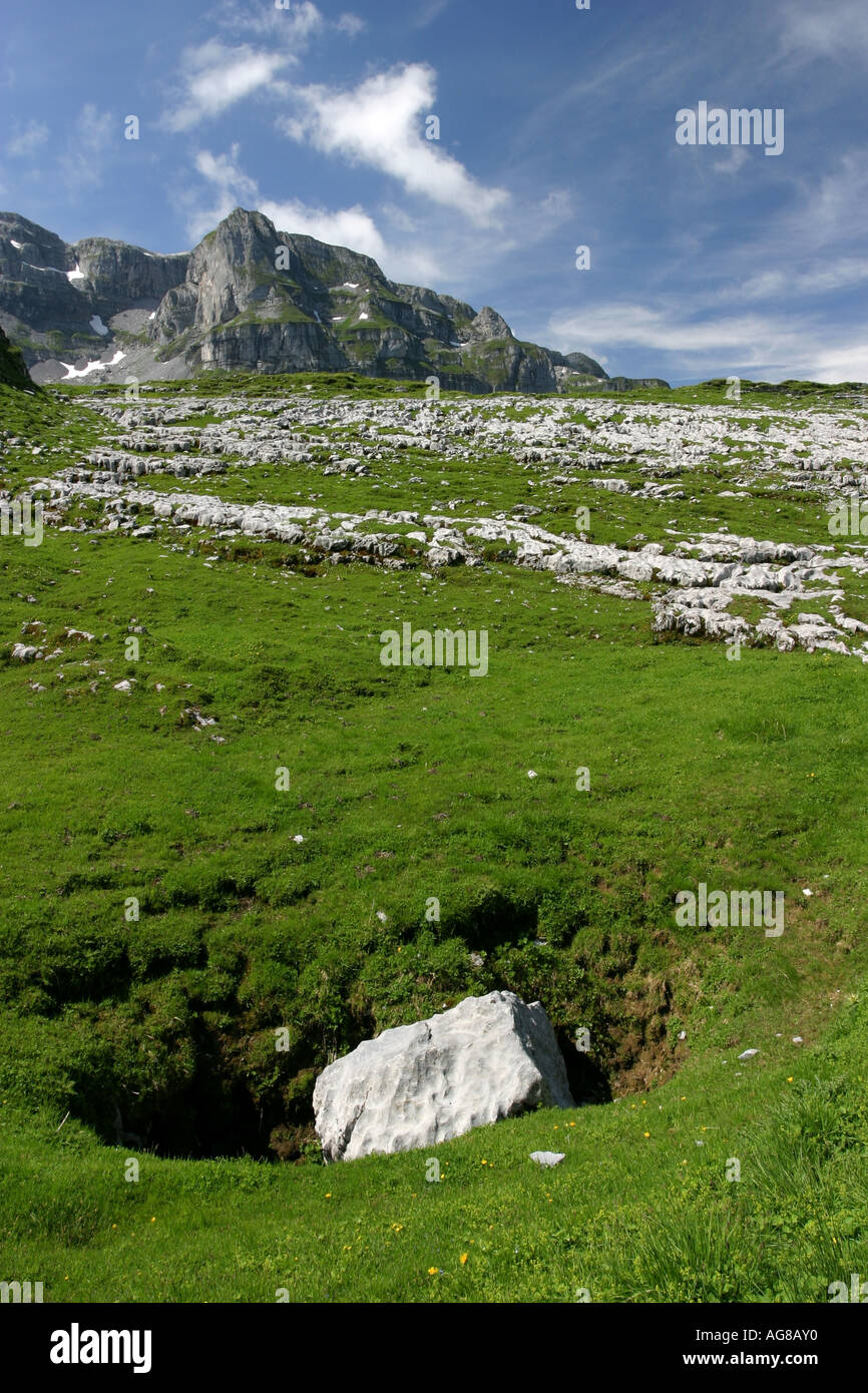 Karst formations with a sinkhole in the foreground on the Glattalp above Muotathal Valley, Switzerland. Stock Photo
