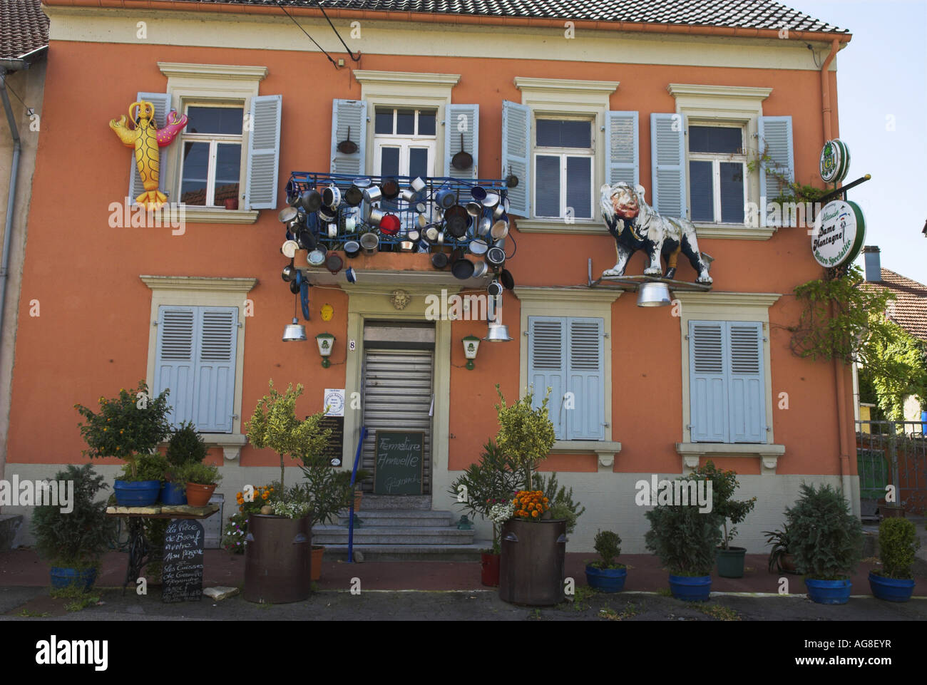 potcladding. Facade of a French gourmet bistro decorated with pots and