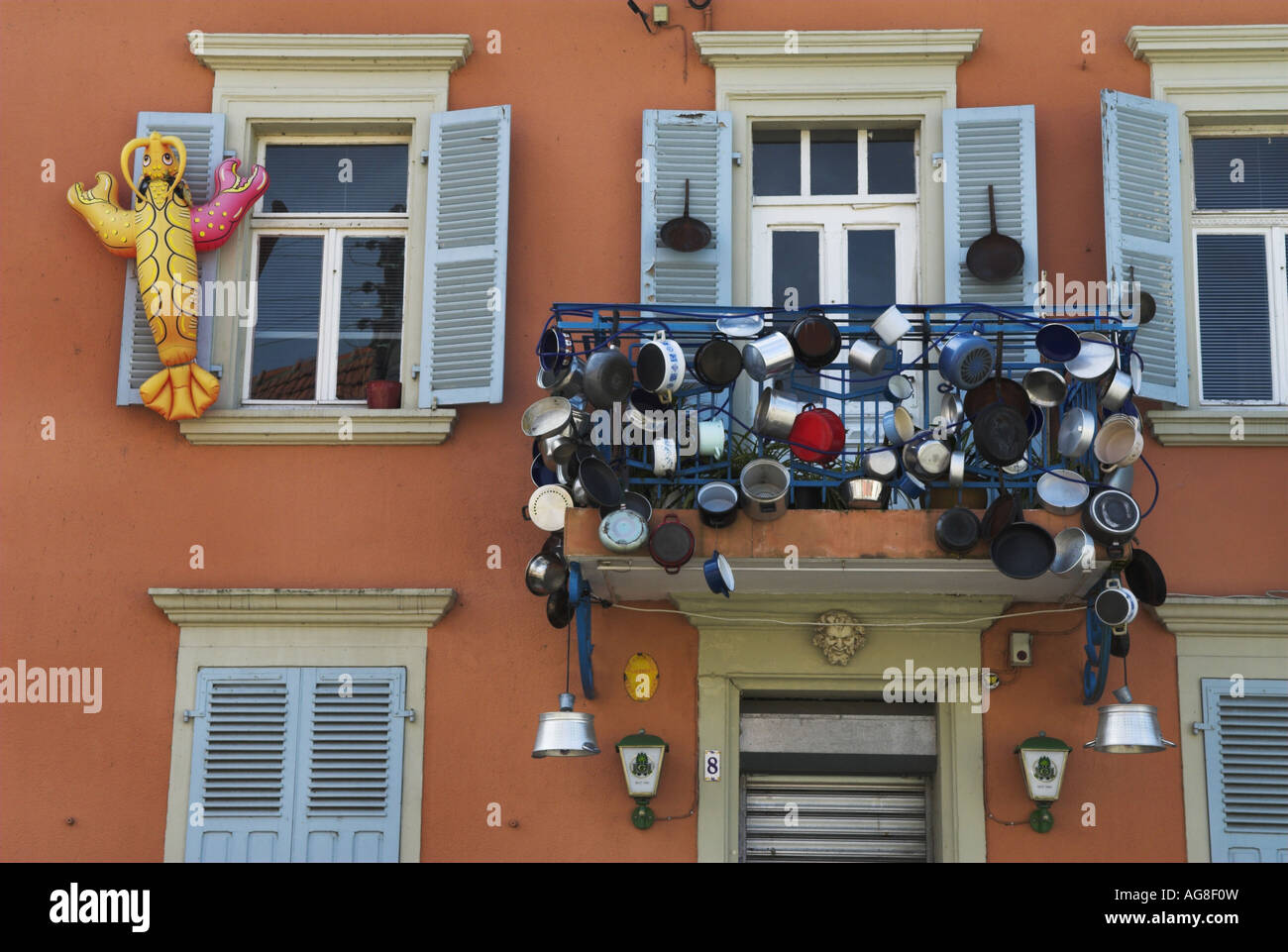 potcladding. Facade of a French gourmet bistro decorated with pots and
