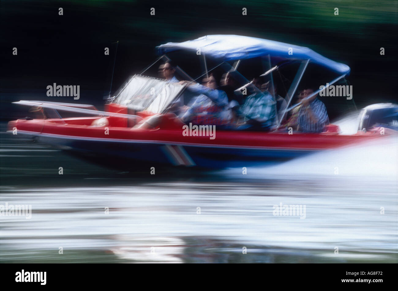 People in a speeding dayboat at Tortuguero Limón Costa Rica Stock Photo