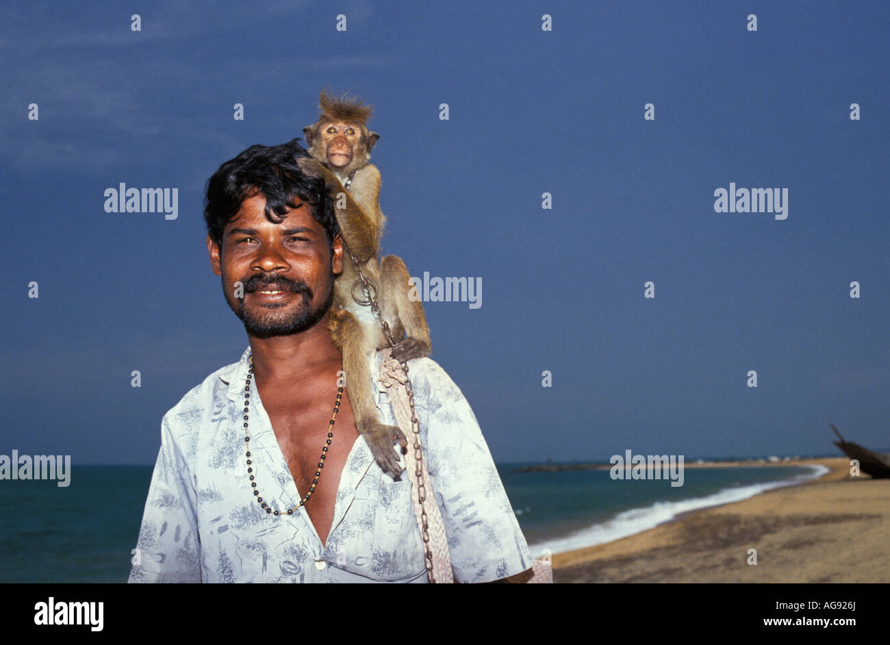 Sri Lanka Negombo, Acrobat with monkey at beach Stock Photo