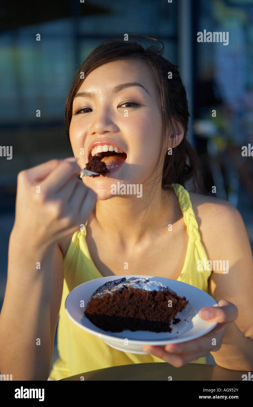 Young Lady Eating Cake Stock Photo Alamy