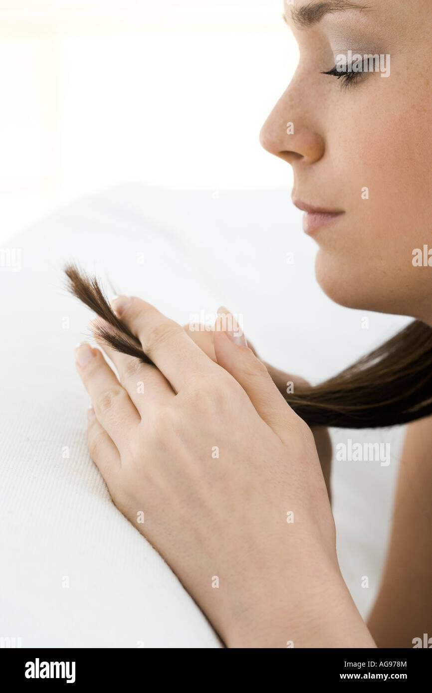Woman looking her hair hi-res stock photography and images - Alamy