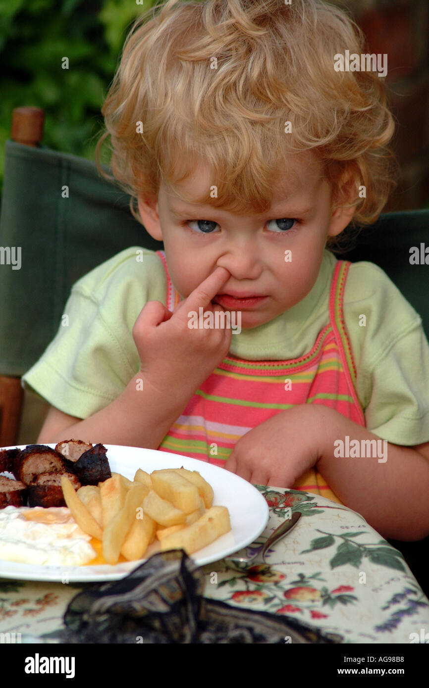 Child Picking Nose Blonde Girl Eating Food Stock Photo Alamy