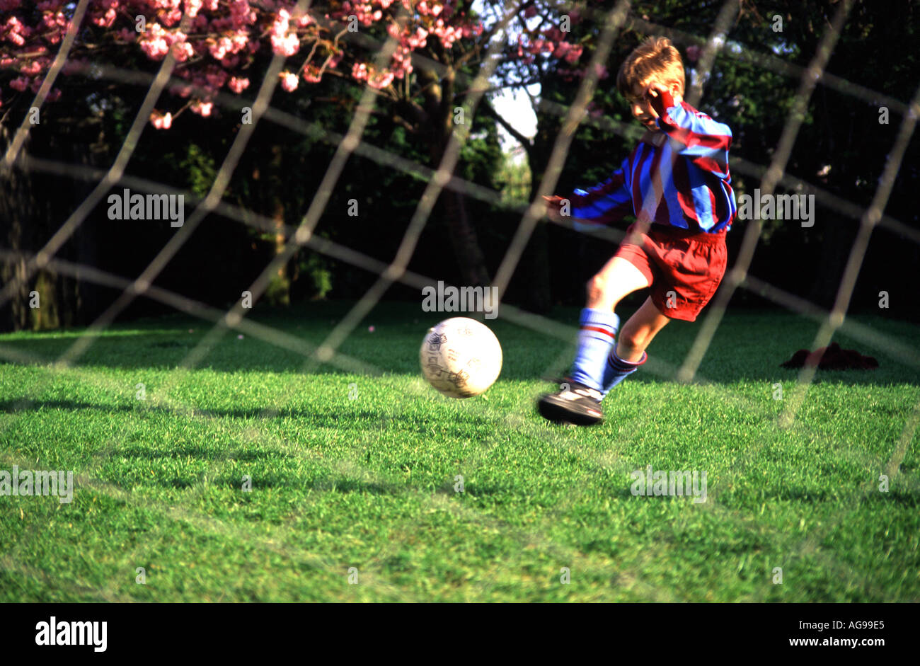 12-14-year-old-boy-playing-football-goal-post-in-foreground-stock-photo-alamy