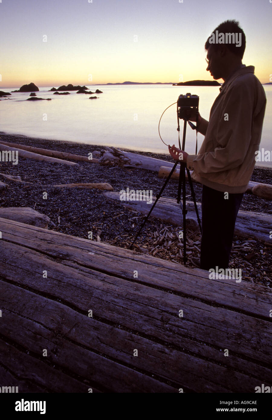 Photographer photographing sunset Deception Pass State Park Fidalgo Island Washington Stock Photo