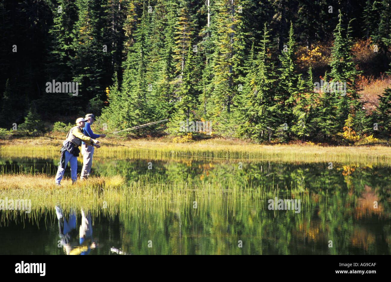Father and son fly fishing subalpine lake Grace Lakes Stevens Pass