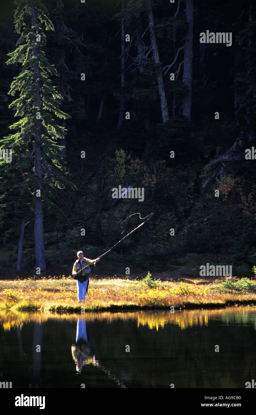 Man fly fishing subalpine lake Grace Lakes Stevens Pass Cascade