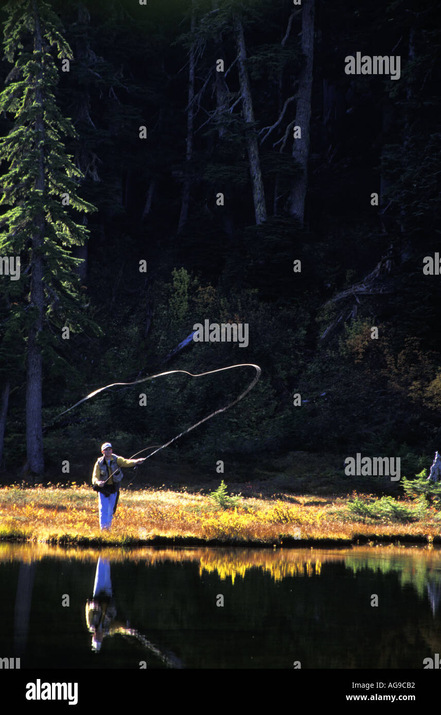 Man fly fishing subalpine lake Grace Lakes Stevens Pass Cascade
