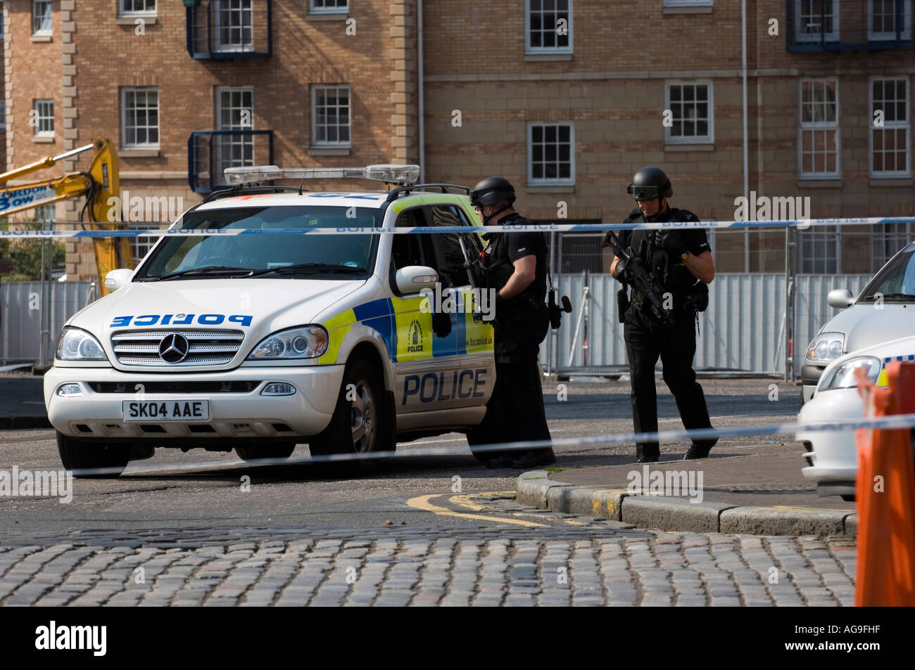 Armed policemen at incident scene in residential area Stock Photo