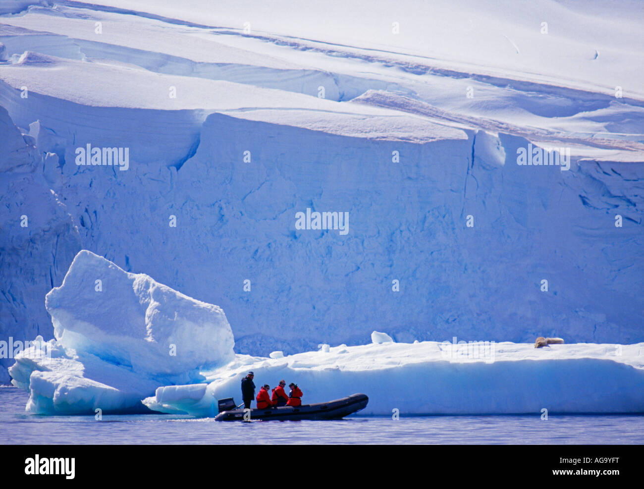 Antarctica, Tourists in inflatable boat by iceberg Stock Photo