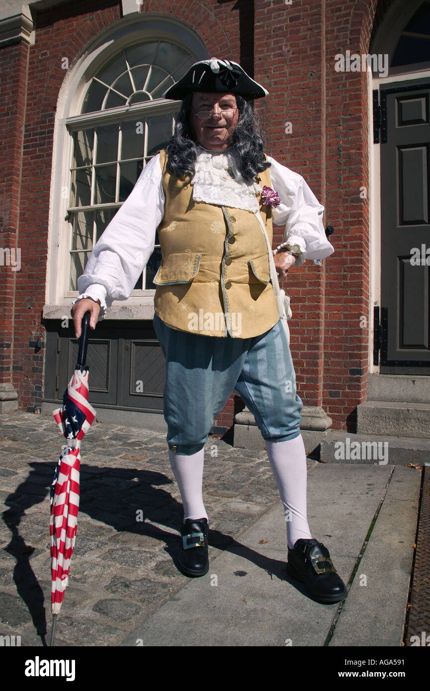 A colonial costumed gentleman dressed to look like Benjamin Franklin poses for photographs at Faneuil Hall in Boston MA Stock Photo