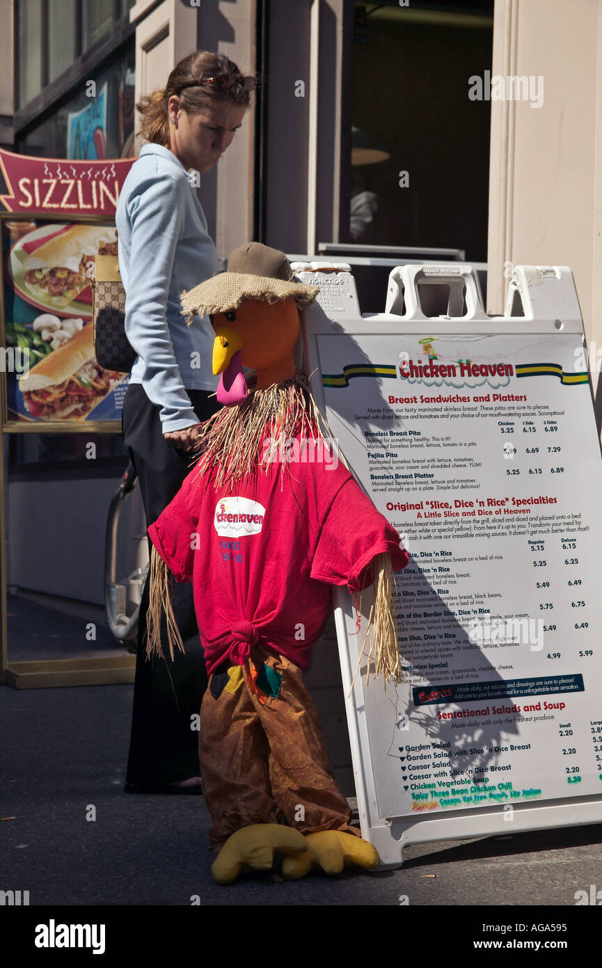 Straw stuffed chicken attached to sandwich board sign at Chicken Heaven