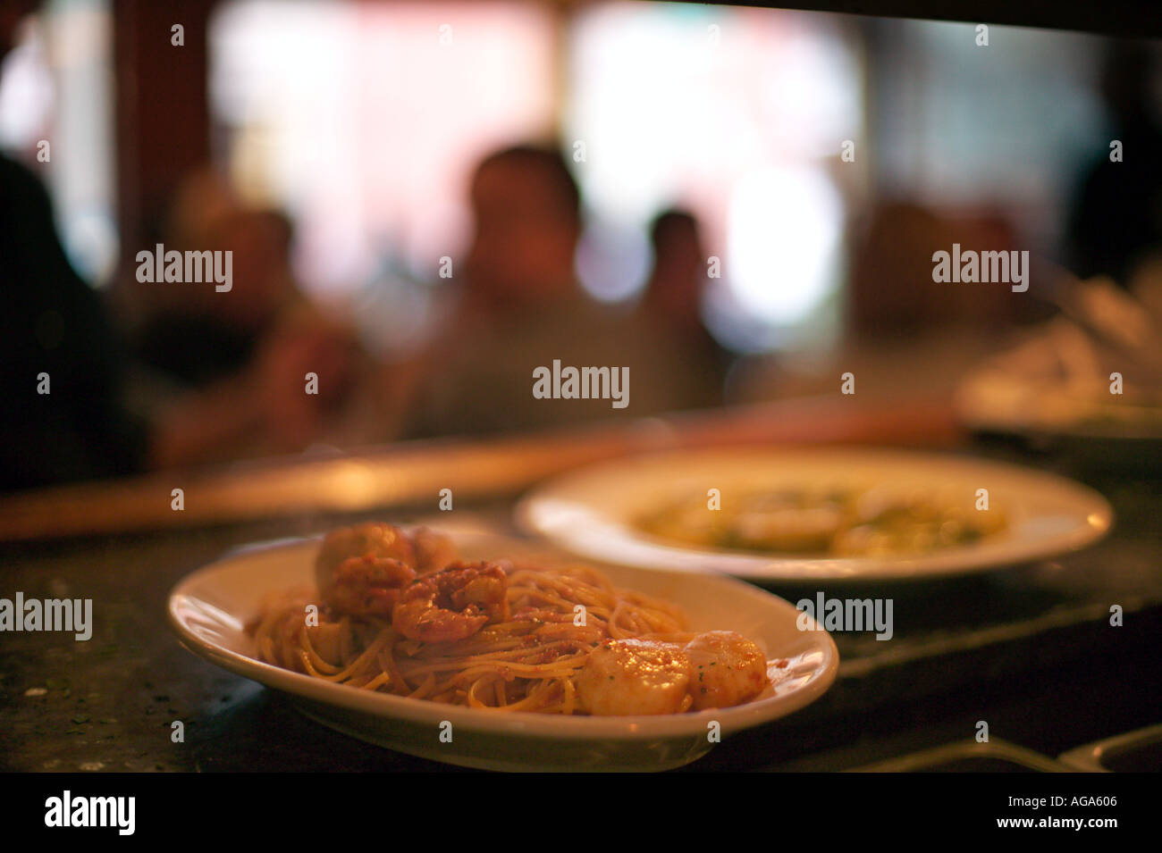 Dinner plates ready in kitchen at Giacomo's Restaurant on Hanover Street Italian district north end Boston MA Stock Photo