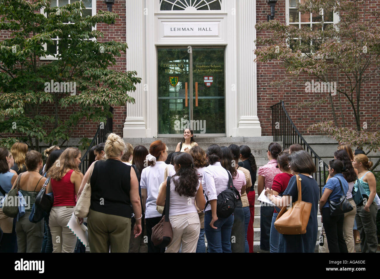 Sophomore student leads introductory tour on steps of Lehmen Hall Old Harvard Yard Harvard University Cambridge MA Stock Photo