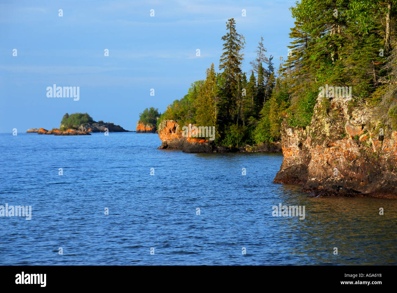 Michigan Isle Royale National Park small rocky islands forest orange algae skyline Stock Photo