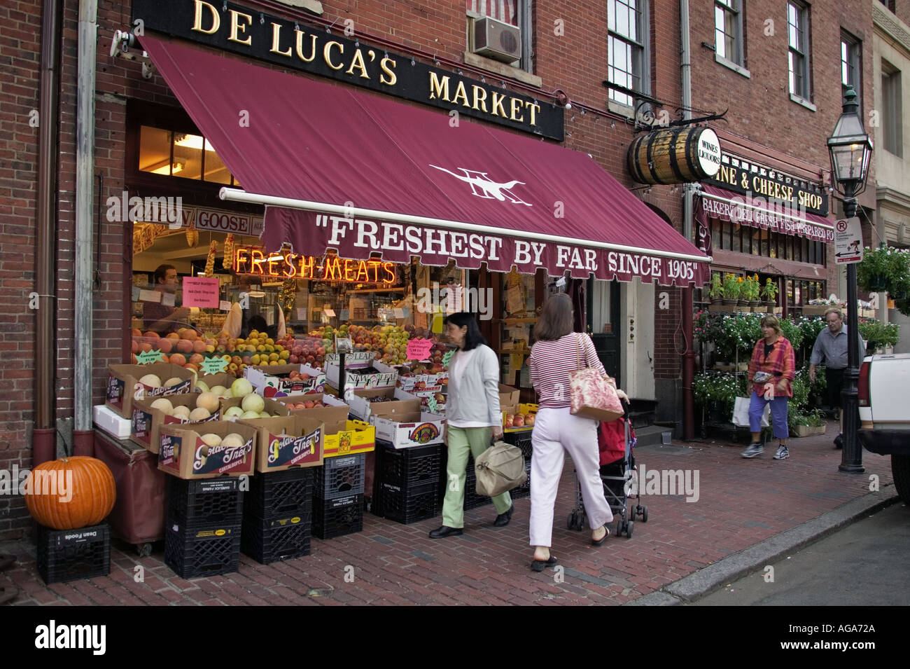 Shoppers on sidewalk in front of De Lucas Market and Deli on Charles