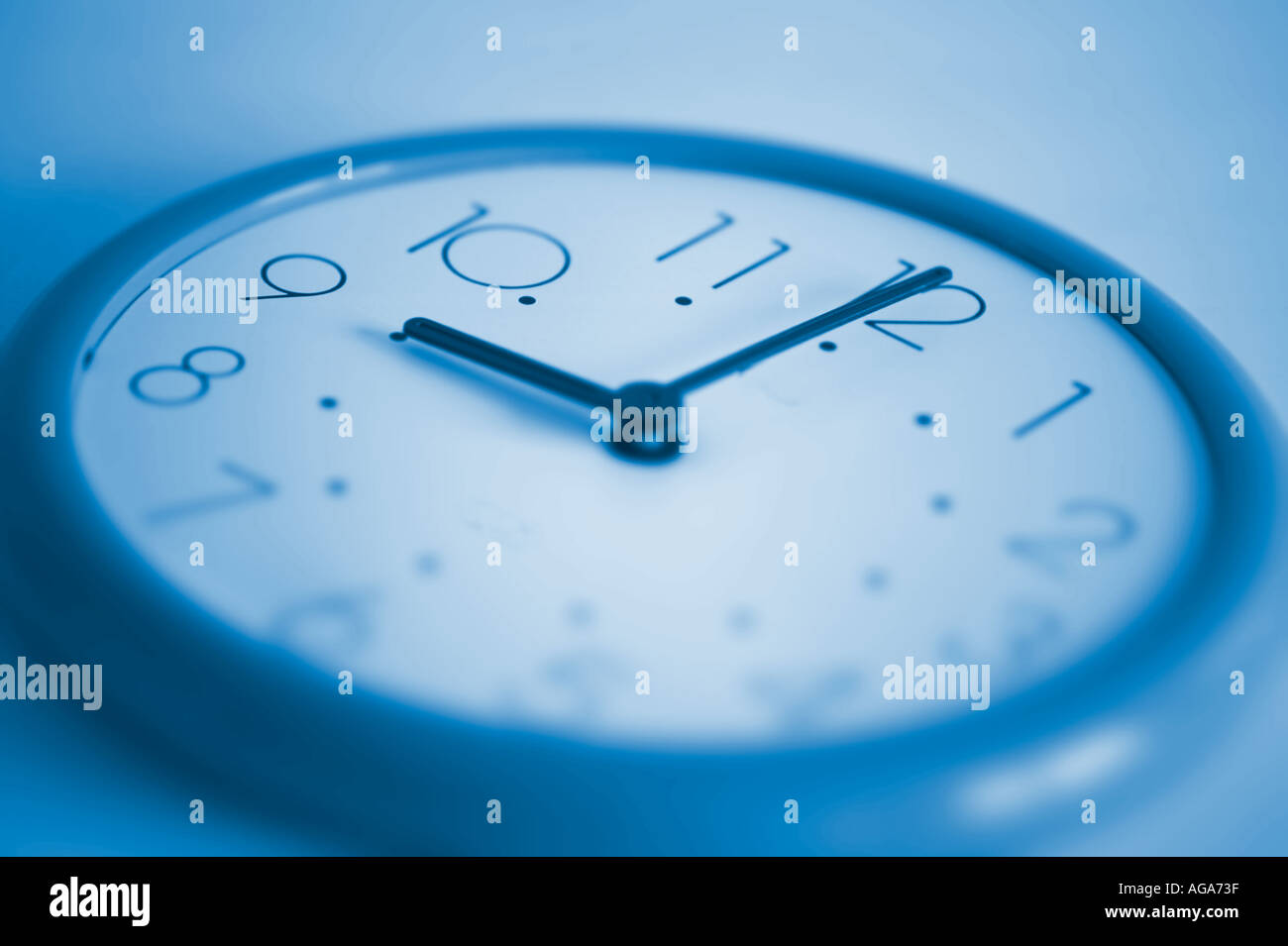 blue clock showing time nine o clock Stock Photo