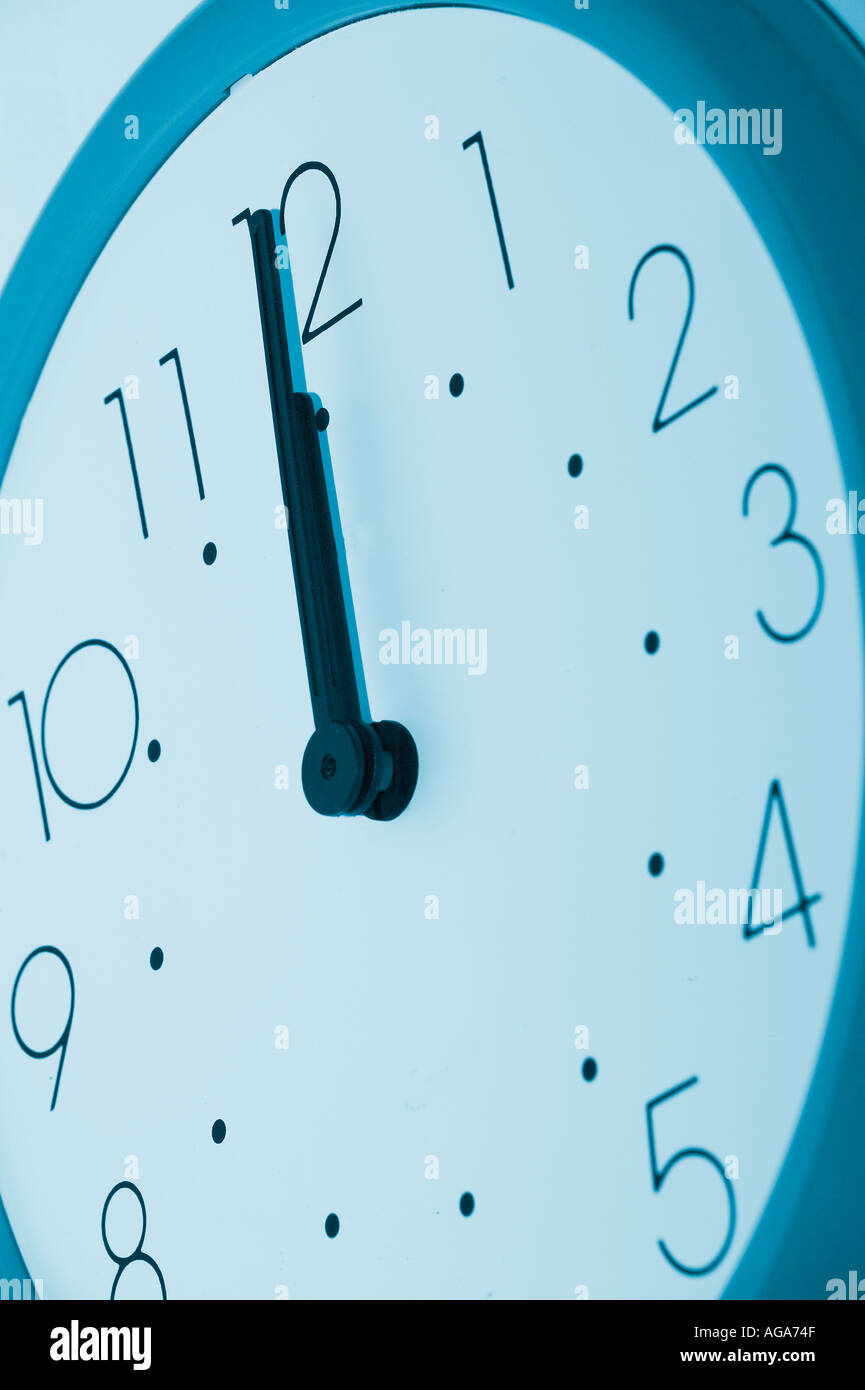 blue clock at noon Stock Photo Alamy