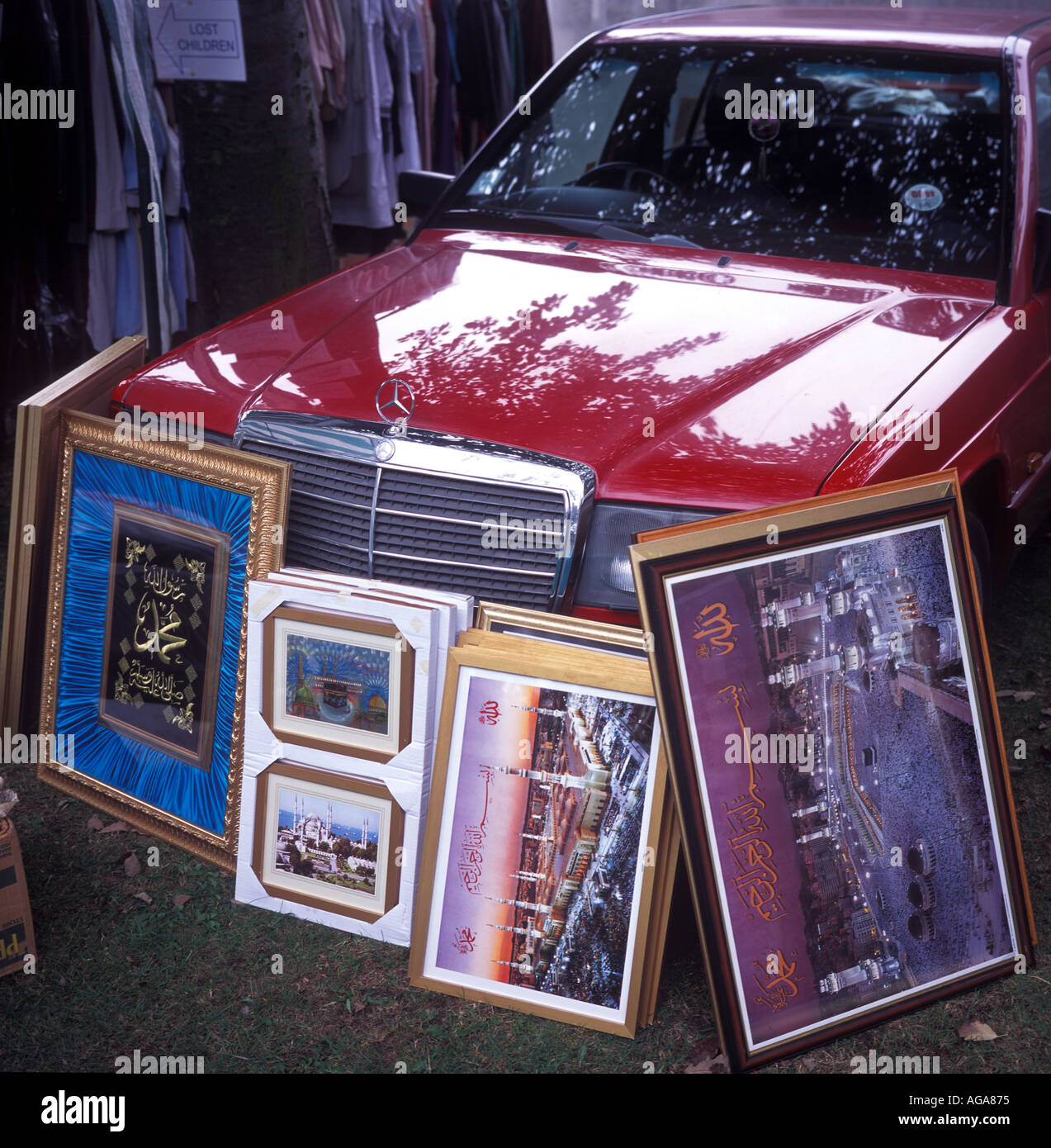 Pictures of Mecca and islamic inscriptions resting against a Mercedes car, Newcastle Mela, UK. Stock Photo