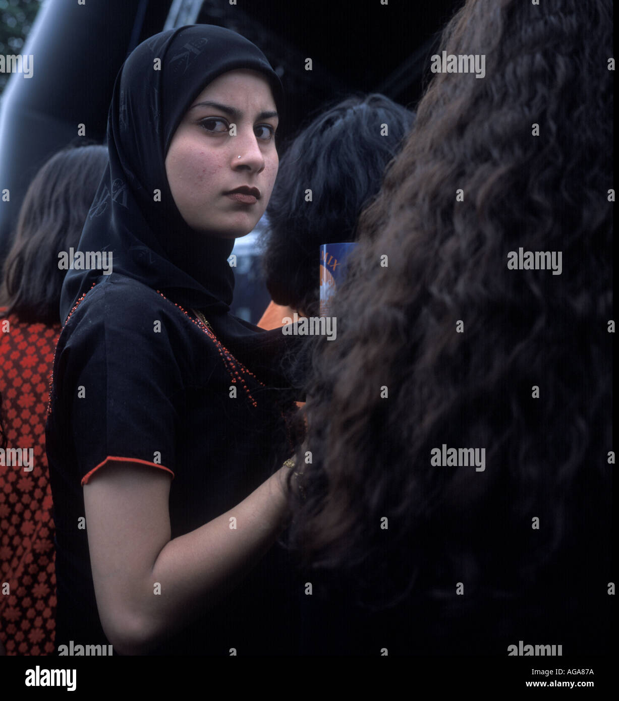 A teenage muslim girl wearing a Calvin Klein head scarf, Slough Mela, UK  Stock Photo - Alamy