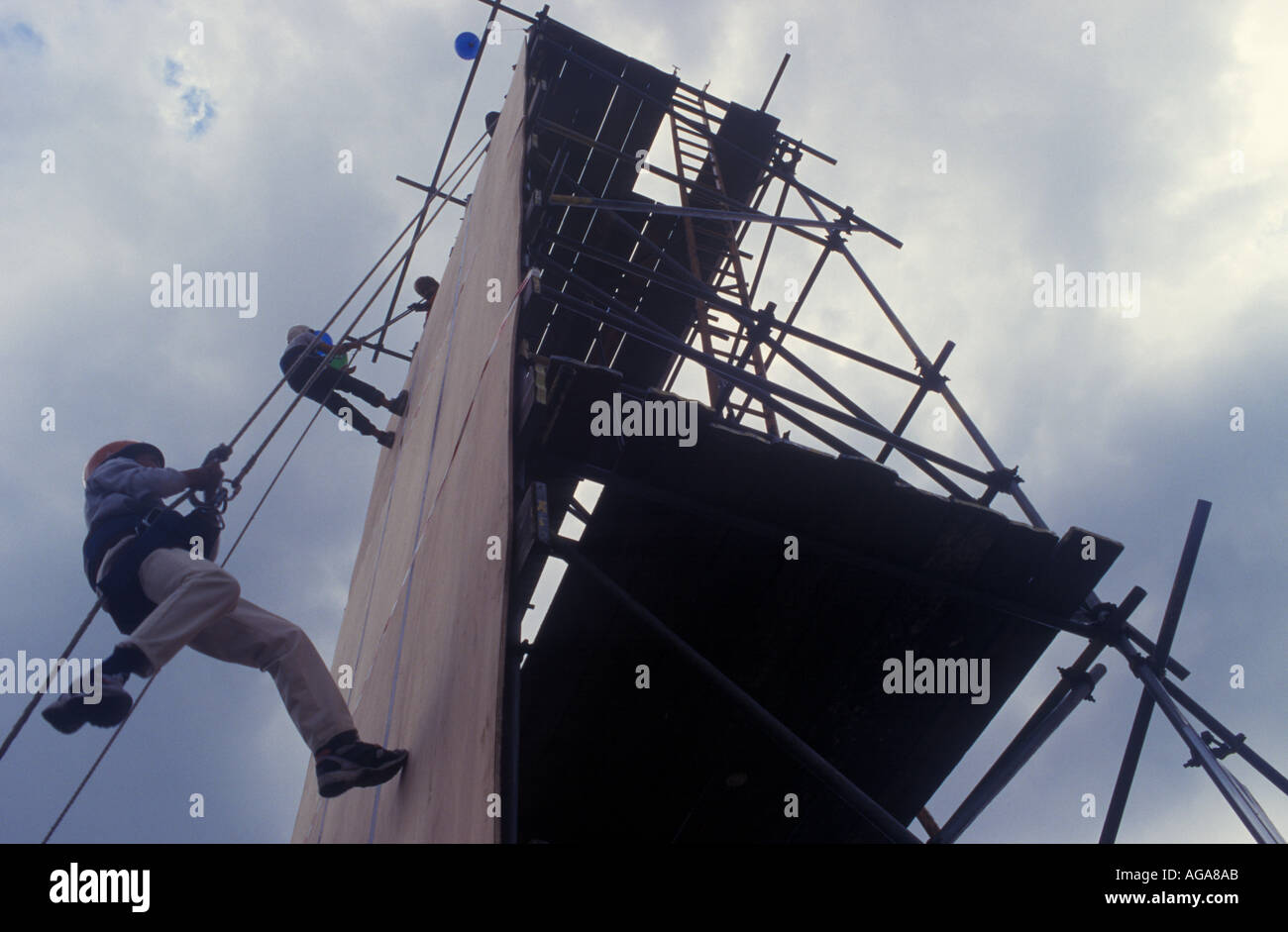 Teenagers climb a scaffold at the Hackney Show, London, UK. Stock Photo