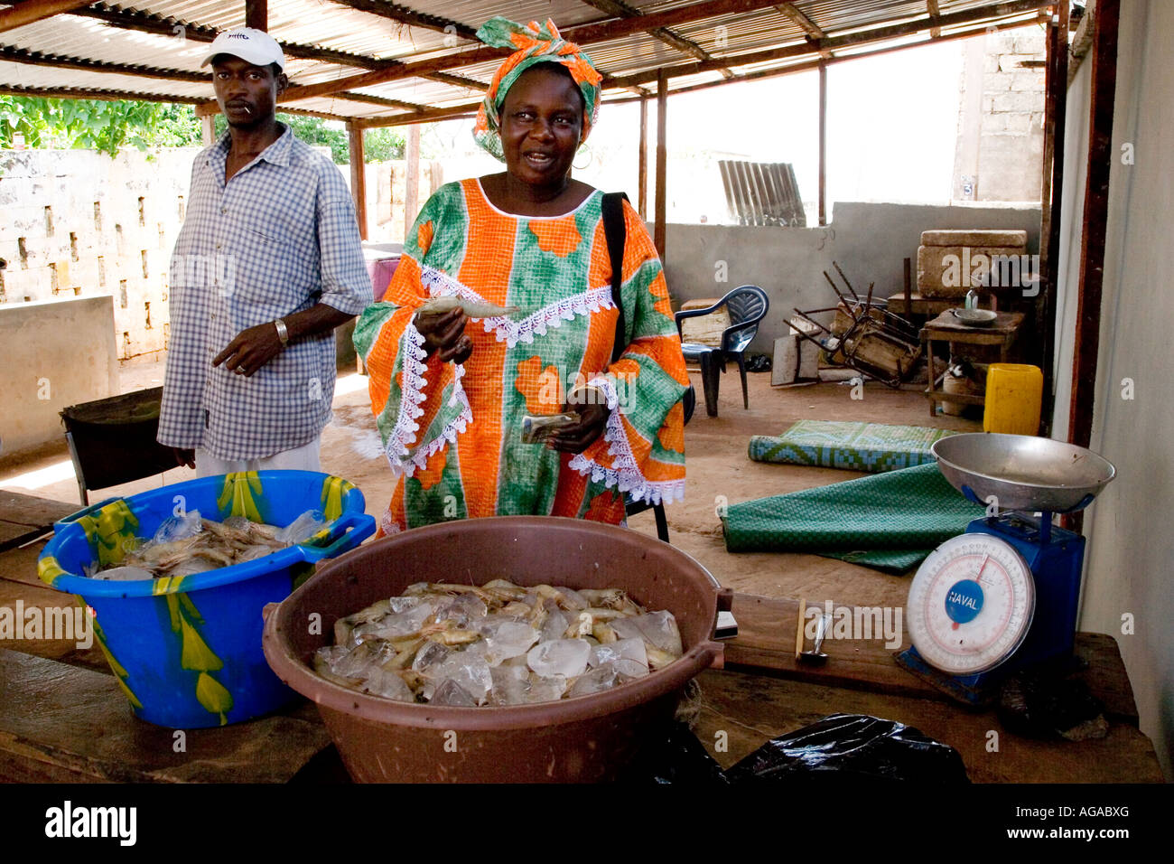 Laughing Gambian woman selling fish at Bakau fish market in The Gambia