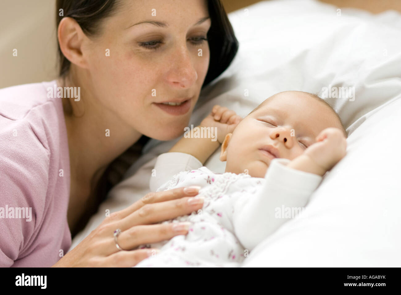 Baby lying asleep with mother Stock Photo Alamy
