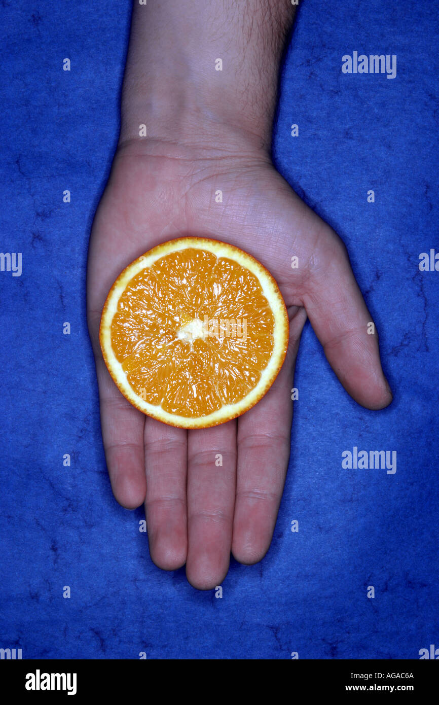 Hand holding half orange hi-res stock photography and images - Alamy