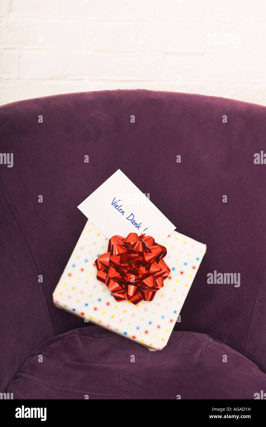 still life of of present with german note vielen dank on arm chair Stock Photo