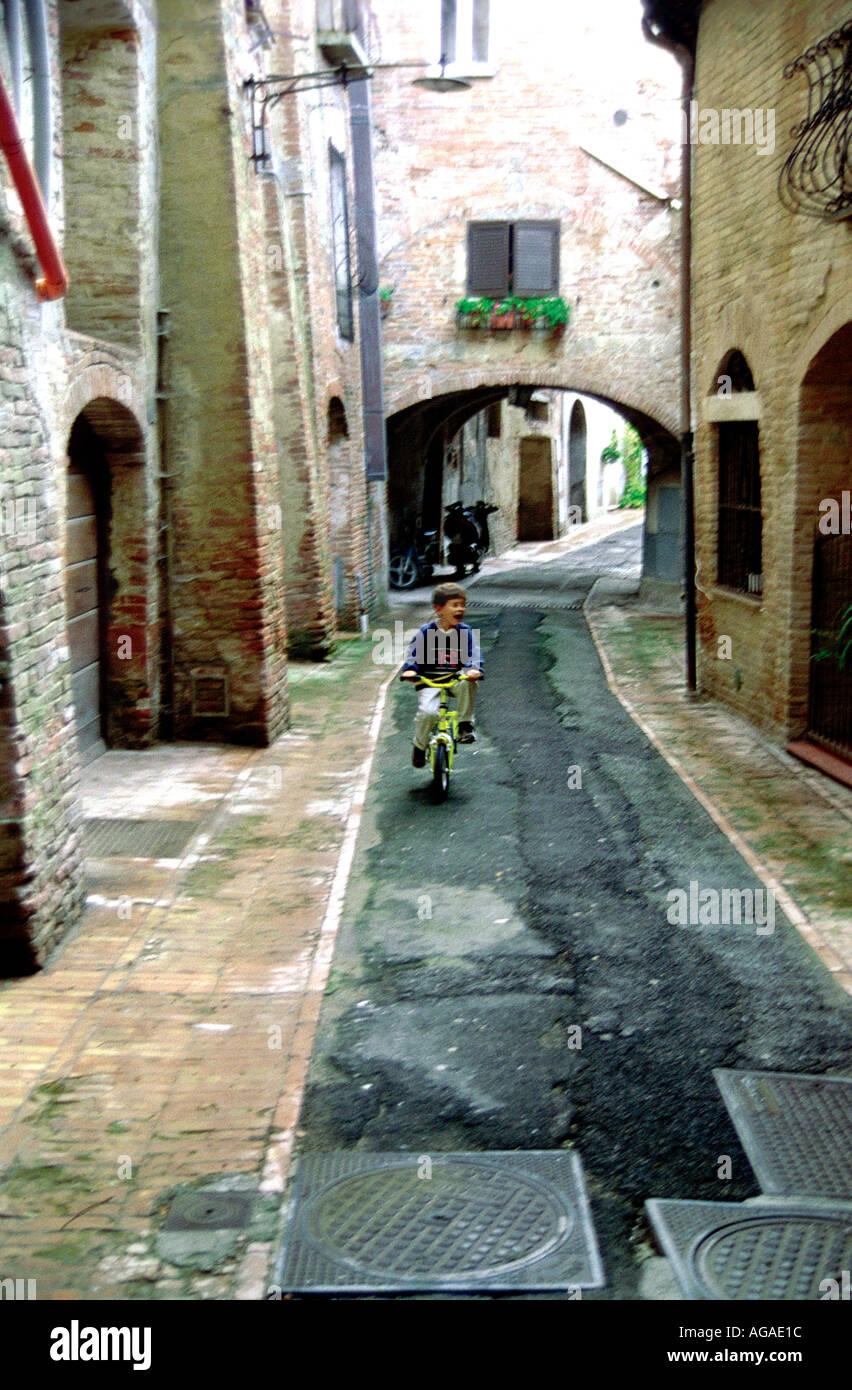 Boy on bike in Cortona Italy Stock Photo