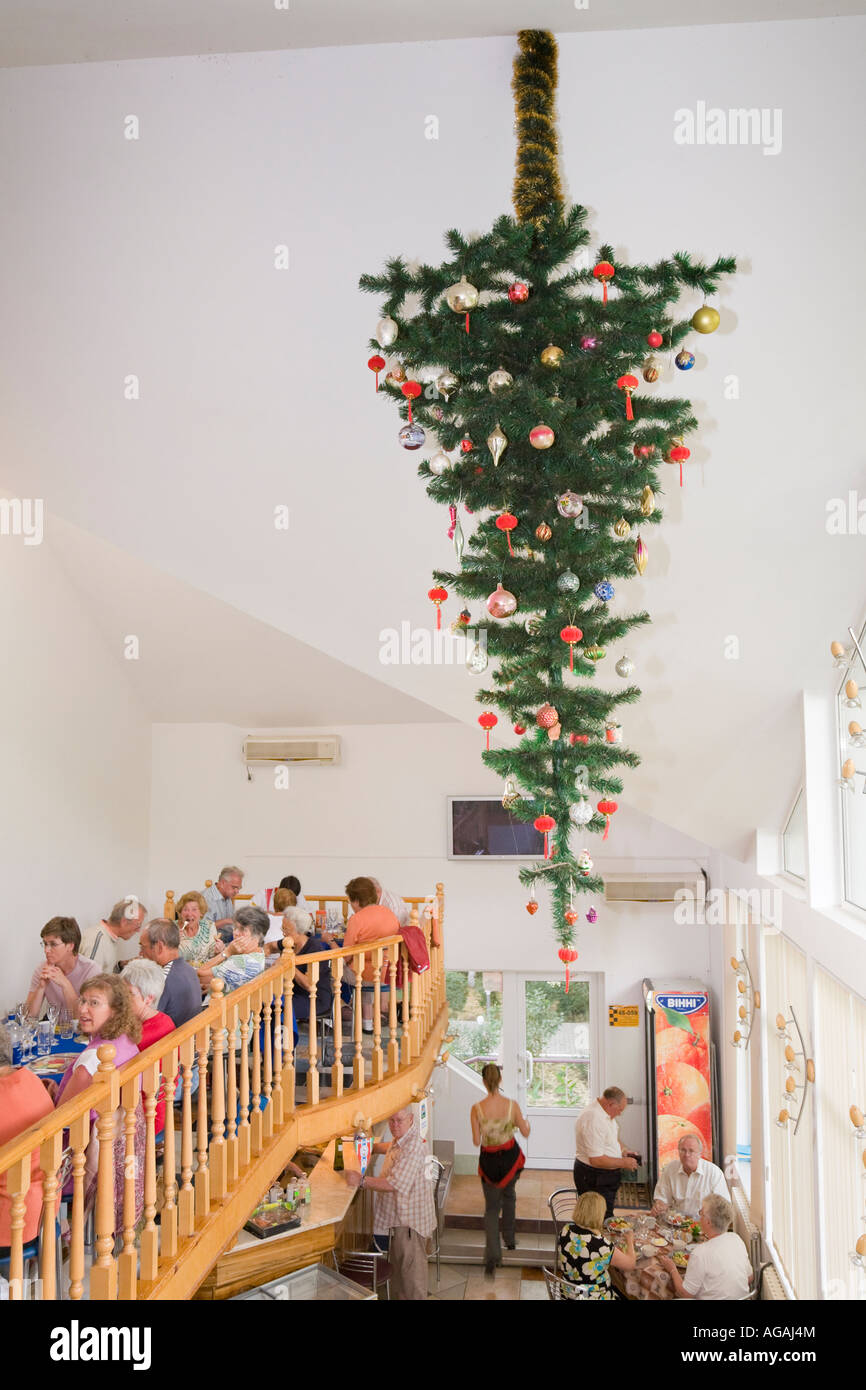 A Decorated Fir Tree Attached To The Ceiling Upside Down In