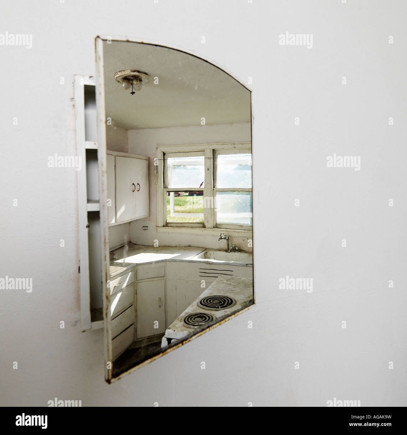 Reflection Of Empty Abandoned Dirty Kitchen In Mirror Stock Photo