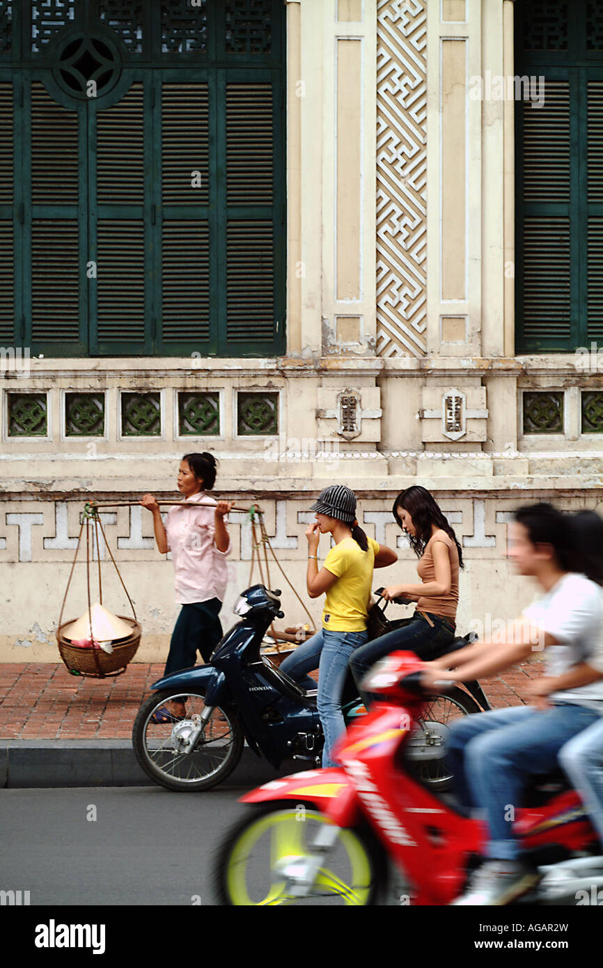 Street trader and young people on scooters in Hanoi in North Vietnam Stock  Photo - Alamy