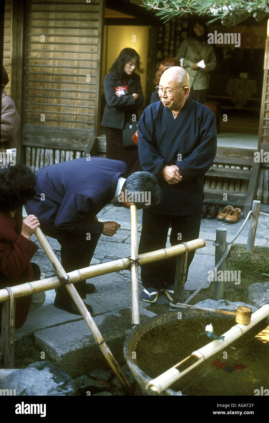 Two Japanese listen to music coming from a music device called