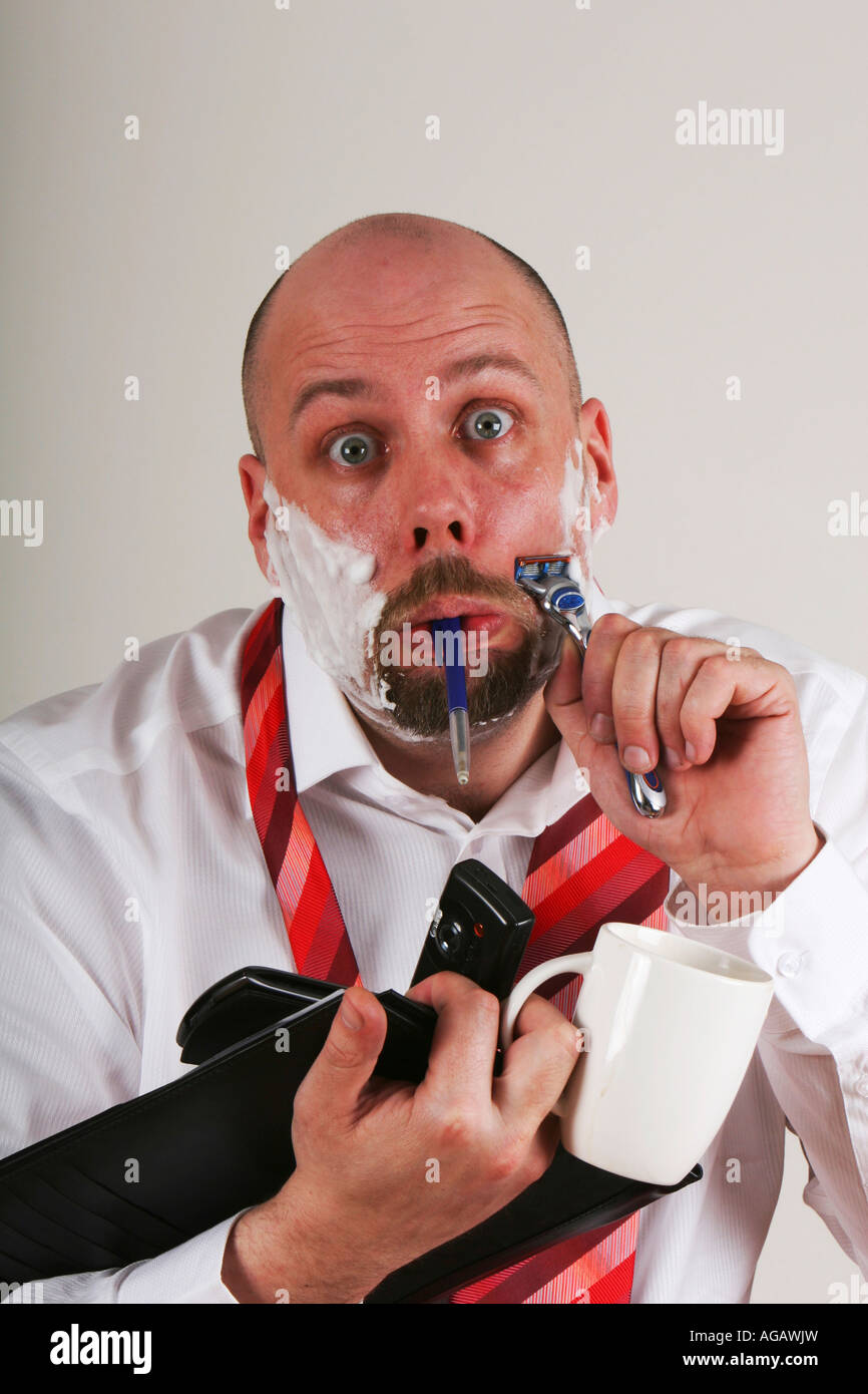 An overworked man doing many things at once with a funny expression Stock  Photo - Alamy